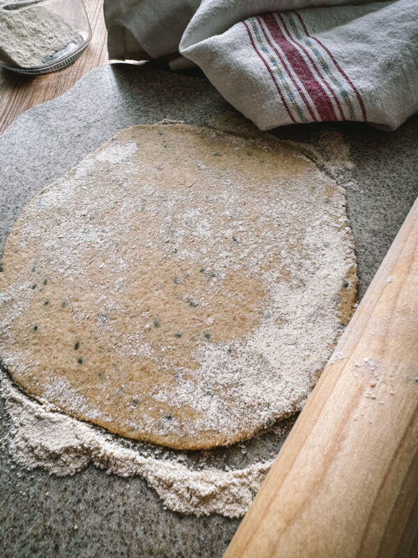 Whole Wheat Einkorn Flatbread Rolled whole wheat einkorn flatbread rolled out on a cutting board