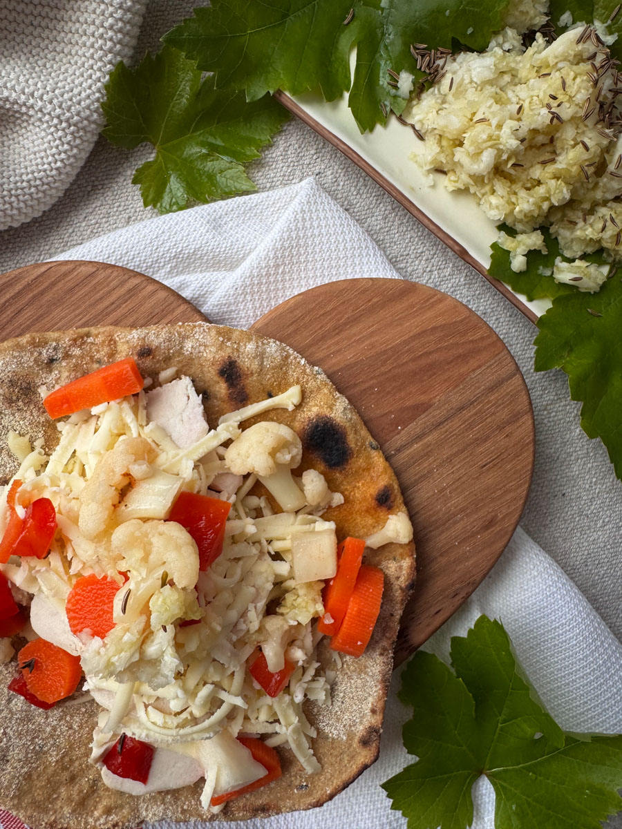 Whole Wheat Einkorn Sourdough Flatbread sourdough einkorn flatbreads topped with chicken, cheese, and fermented vegetables