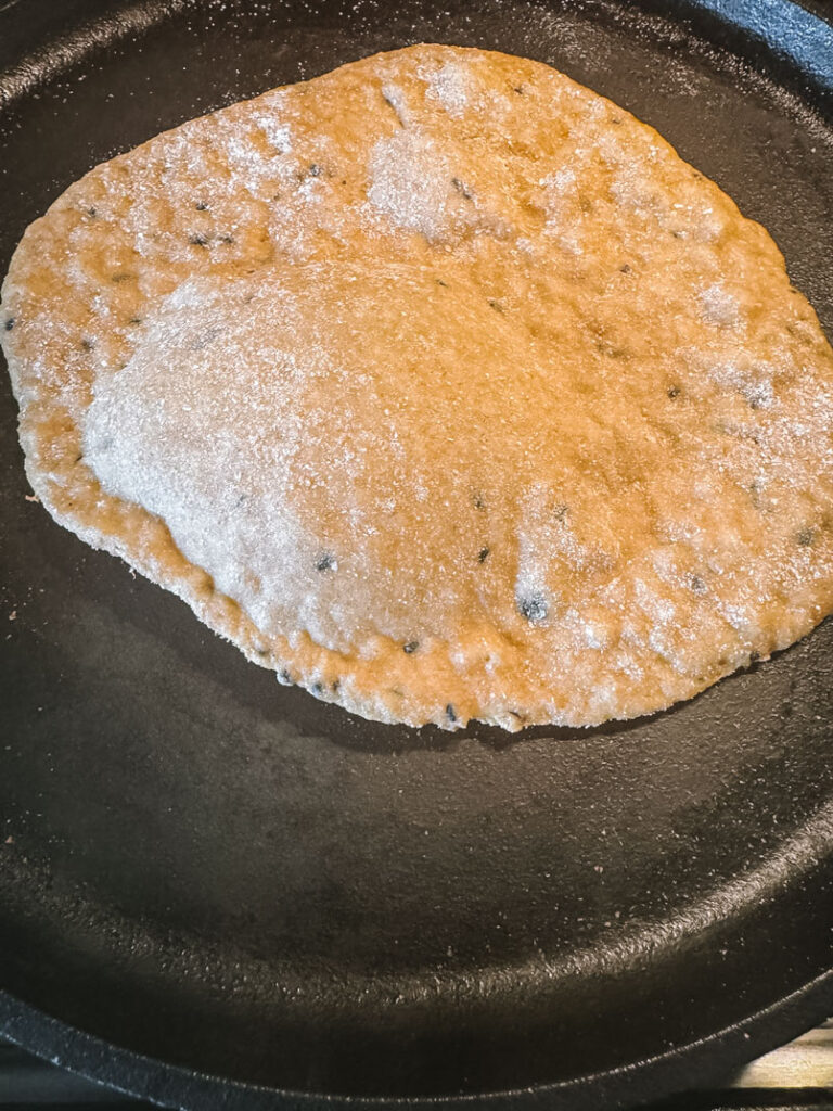 Flatbread on Cast-Iron Pan einkorn wheat flatbread cooked on a cast iron pan