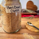 Whole wheat einkorn sourdough breadcrumbs in a jar with a label