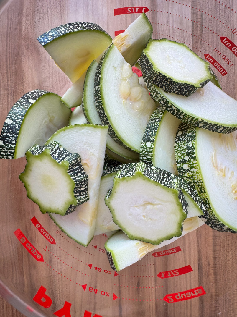 sliced summer zucchini in a measuring dish