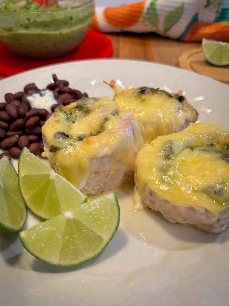roasted poblano chicken dinner with black beans and lime wedges