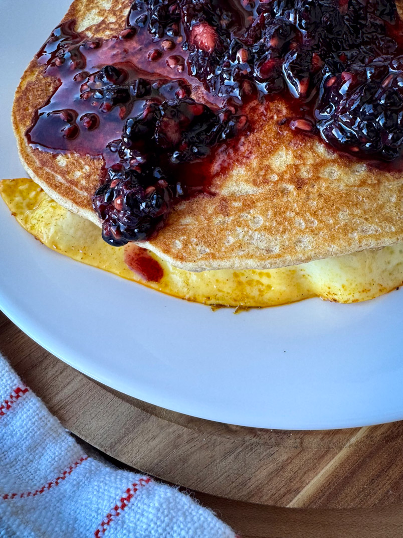 einkorn pancakes with fried eggs and blackberries