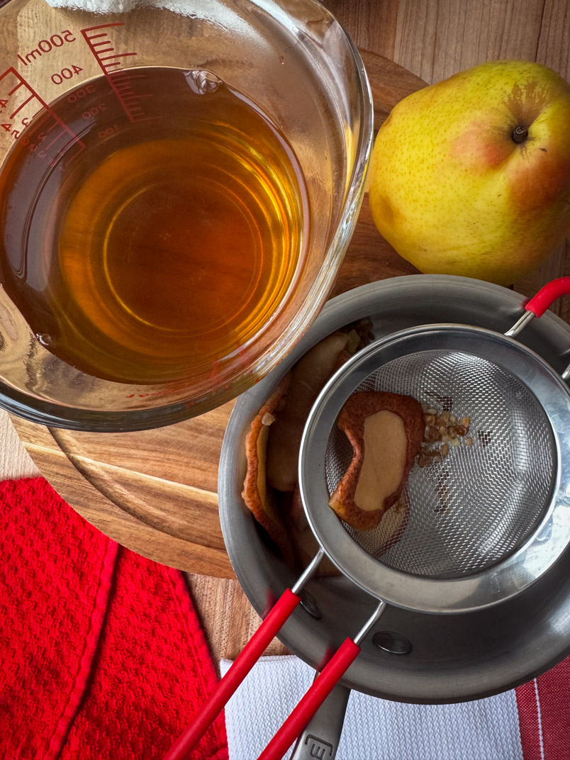 straining spices from pear tea