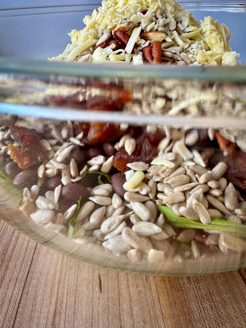 Salad toppings cover romaine salad in serving bowl Salad toppings cover romaine salad in serving bowl