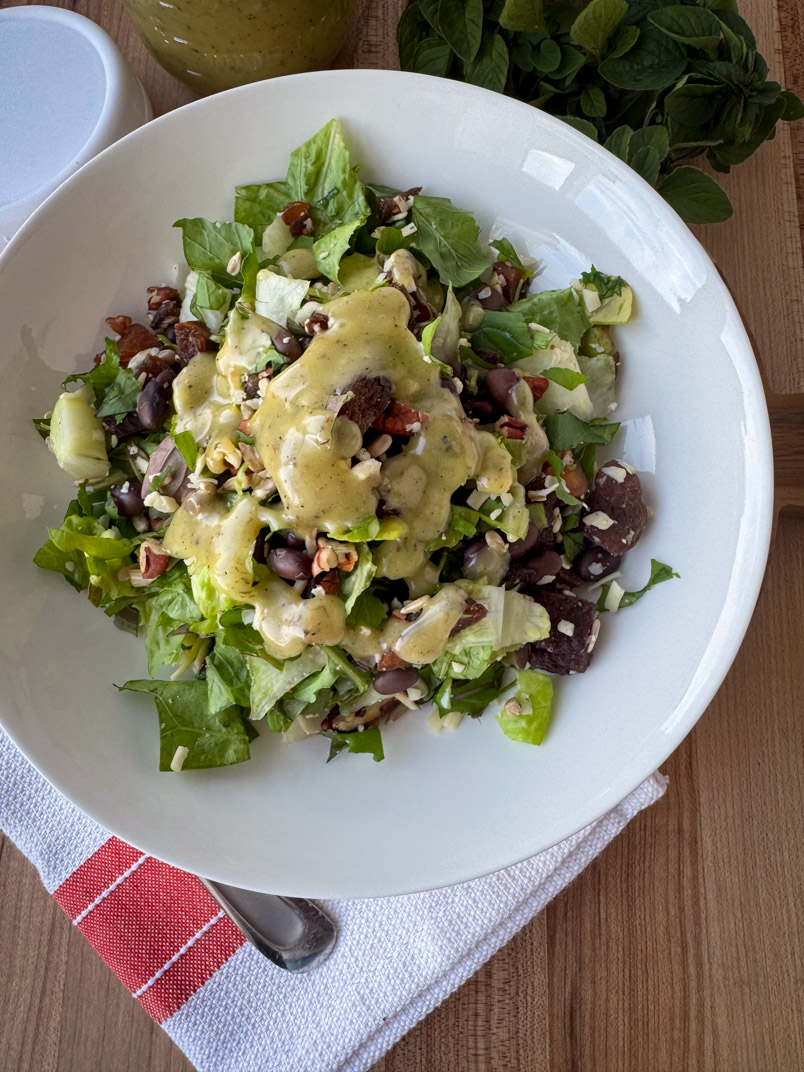 oregano vinaigrette salad dressing on a homemade salad