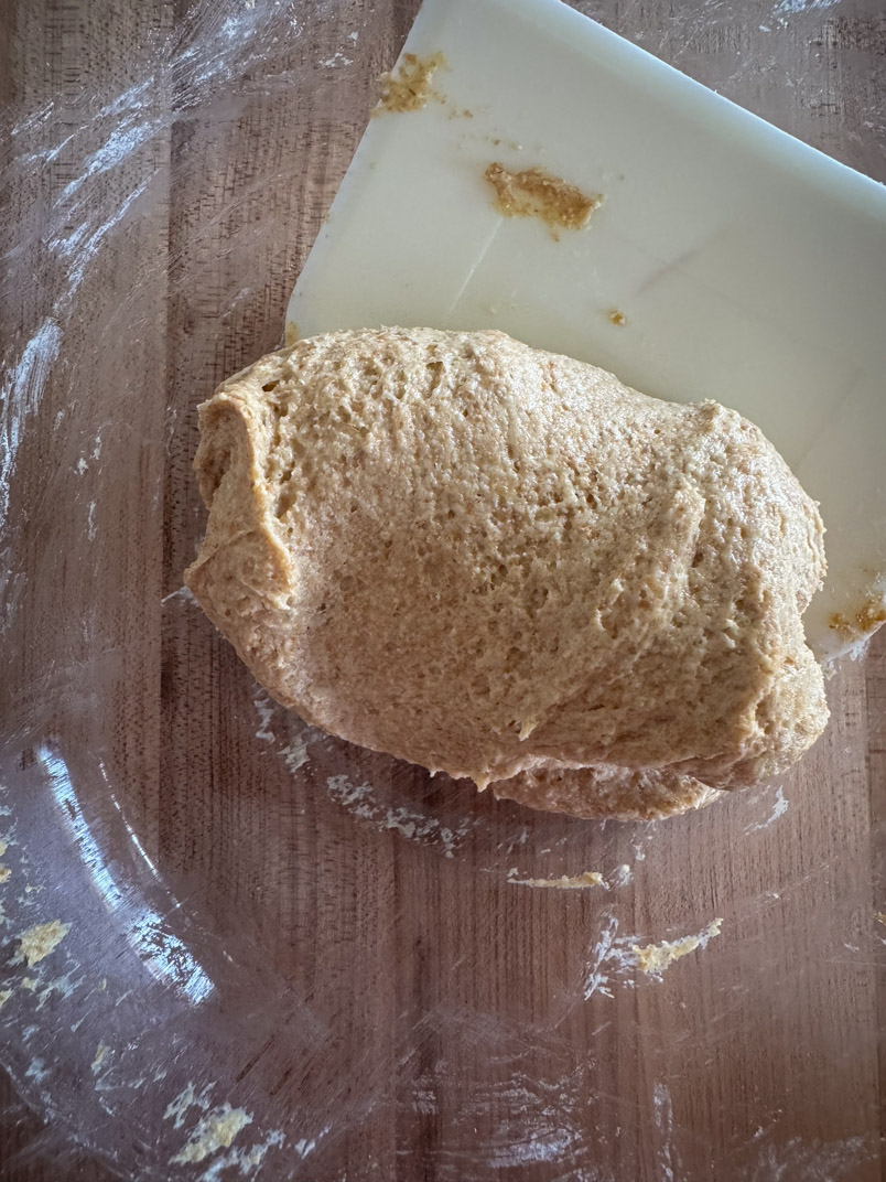 Use a dough scraper to stir and fold dough
